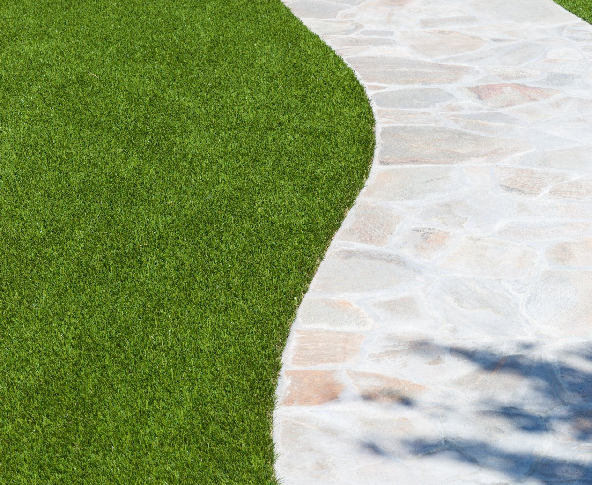 path paving stones surrounded by artificial grass in a property in Tucson AZ